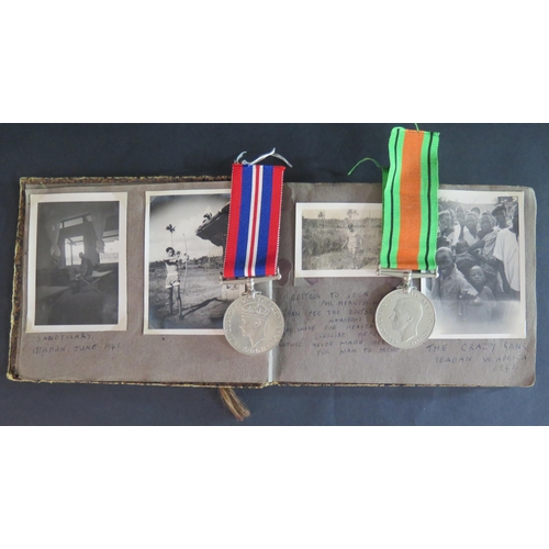 411 - A WWII British Ware Medal (1939-45), Defence Medal and photograph album including Ibadan W. Africa