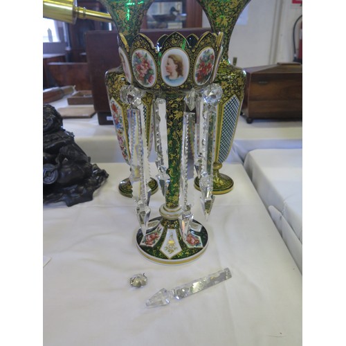 369 - A 19th Century Bohemian Glass Garniture, the green ground with white opaque overlay and polychrome f... 