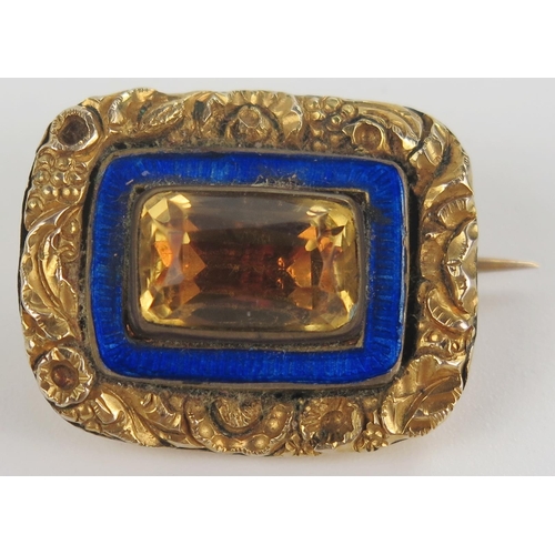 10 - Georgian Unmarked Gold Brooch set with a foil backed citrine or paste and with a blue enamel surroun... 