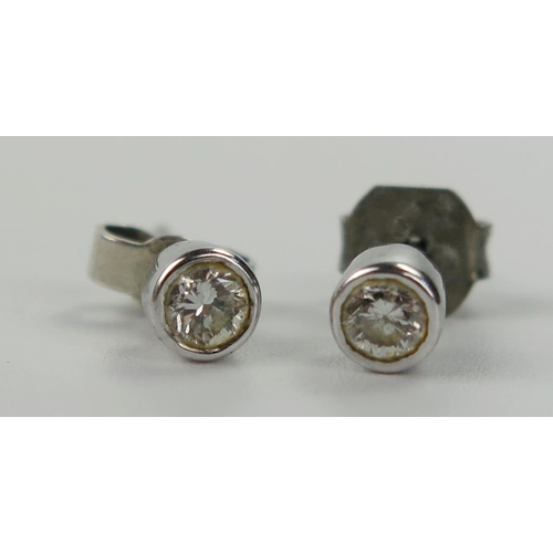 118 - Pair of 18ct White Gold and Diamond Stud Earrings in a rub over setting, c. 3.2mm stones, 1.2g