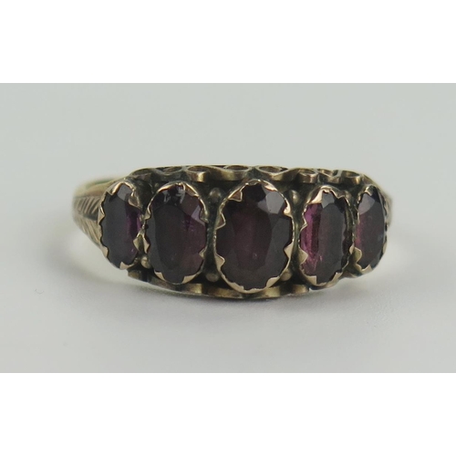 139 - Early Victorian 22ct Gold and Foil Backed Garnet Five Stone Ring with foliate engraved shoulders, 17... 