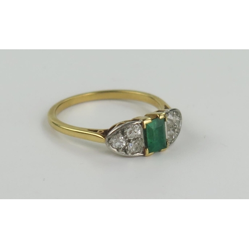 162 - An Emerald and Diamond Ring in an unmarked high carat gold setting, the c. 5.7x 4.6mm emerald flanke... 