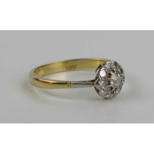 203 - An 18ct Gold and Diamond Ten Stone Cluster Ring, central stone c. 3mm, 8.5mm head, size R.75, 3.6g