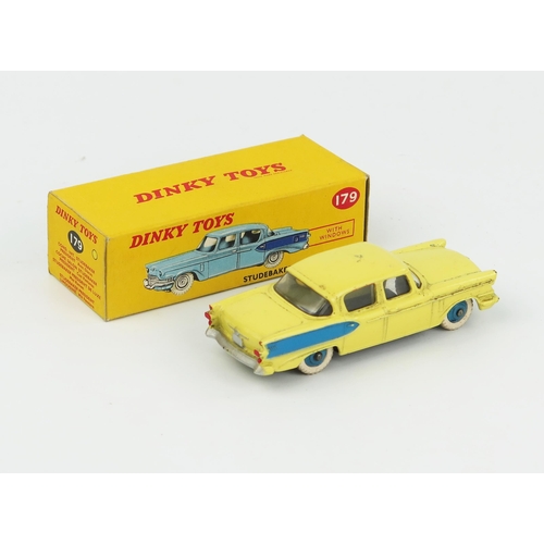 2074 - A Dinky Toys 179 Studebaker President Sedan in light yellow with blue flash and hubs in correct colo... 