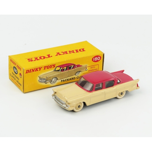 2075 - A Dinky Toys 180 Packard Clipper Sedan with cerise upper body, cream lower body and hubs in correct ... 