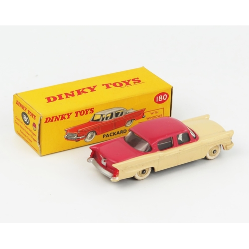 2075 - A Dinky Toys 180 Packard Clipper Sedan with cerise upper body, cream lower body and hubs in correct ... 