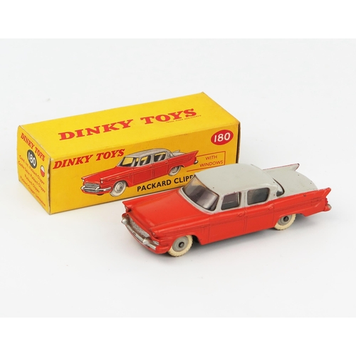 2076 - A Dinky Toys 180 Packard Clipper Sedan with grey upper body, orange lower body and grey hubs in corr... 