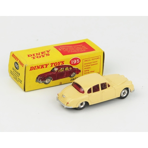 2095 - A Dinky Toys 195 Jaguar 3.4 Saloon in cream with red interior, spun hubs and gloss black base in lig... 