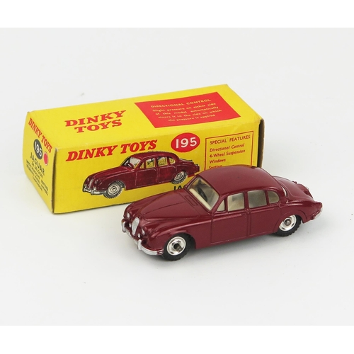 2096 - A Dinky Toys 195 Jaguar 3.4 Saloon in maroon with white interior, spun hubs and gloss black base in ... 