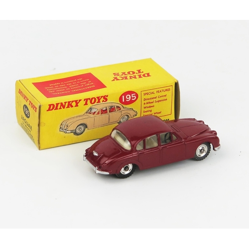 2096 - A Dinky Toys 195 Jaguar 3.4 Saloon in maroon with white interior, spun hubs and gloss black base in ... 