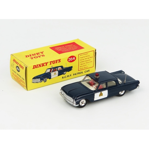 2234 - A Dinky Toys 264 Ford Fairlane RCMP Patrol Car in dark blue with white doors and interior, spun hubs... 