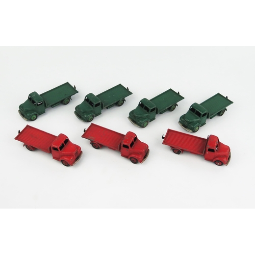 2318 - Seven Dinky Toys 30R Fordson Thames Flat Trucks - four dark green with green hubs, three red with re... 