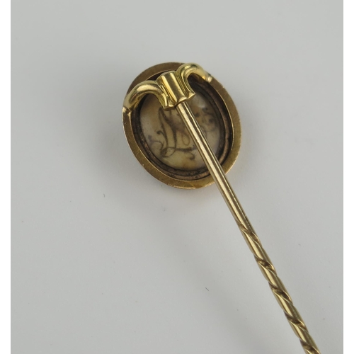 234 - Georgian Memorial Pin, the unmarked 15ct gold case set with a woven hair panel with hematite surroun... 