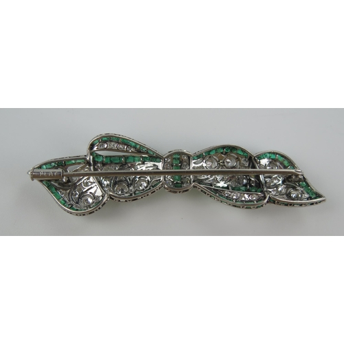 235 - A Belle Epoque Platinum, Emerald and Diamond Millegrain Set Bow Brooch, the principal 3mm diamonds w... 