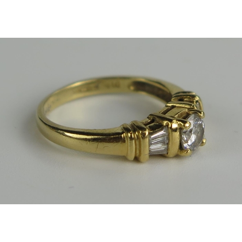 408a - An 18K Yellow Gold and Diamond Ring, the central stone estimated at .44ct and flaked by three baguet... 