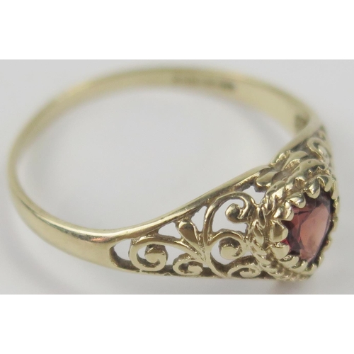 43 - 9ct Gold and Garnet Ring with a heart shaped head and pierced foliate shoulders, size Q, 1.6g