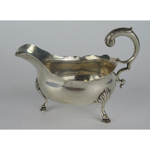 637 - George III Silver Sauce Boat with foliate scroll handle and standing on three hoof feet, 14.5cm long... 