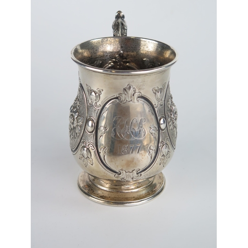 641 - Victorian Silver Mug with embossed foliate decoration, 11cm to handle, London 1877, Thomas White, 18... 