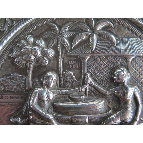 648 - Indian Embossed Silver Dish decorated  with seated ladies  with building and foliate scroll border, ... 