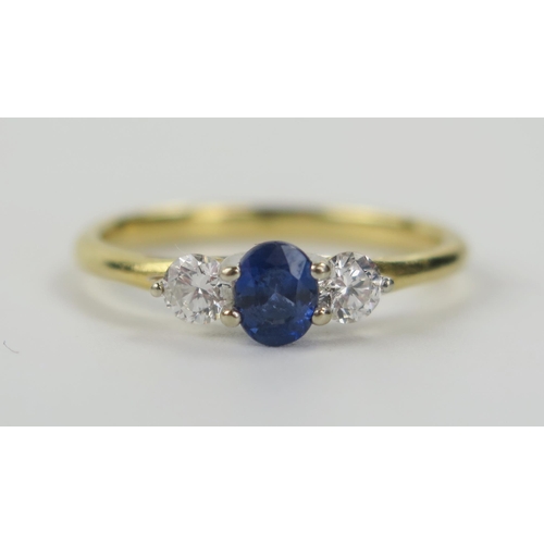 74 - A Modern 18ct Yellow Gold, Sapphire and Diamond Trilogy Ring, the principal 5 x 4mm stone flanked by... 