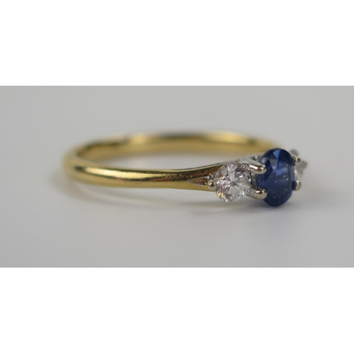 74 - A Modern 18ct Yellow Gold, Sapphire and Diamond Trilogy Ring, the principal 5 x 4mm stone flanked by... 