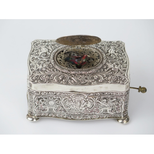 765 - Silver Bird Box Automaton with embossed putti and foliate decoration, c. 11(w)x6(h)x8(d)cm