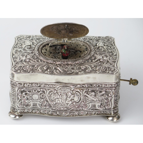 765 - Silver Bird Box Automaton with embossed putti and foliate decoration, c. 11(w)x6(h)x8(d)cm