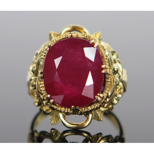 130 - LARRY 14K Gold and Ruby Ring in an ornate foliate setting, stone c. 13x11x8mm, size M.5, 7.4g