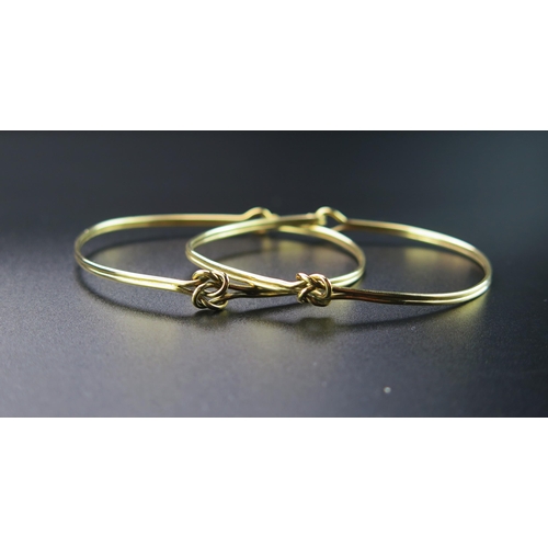 142 - A Pair of 18ct Gold Bangles with knotted decoration, 10.5g. Sold with André Bogaert insurance valuat... 