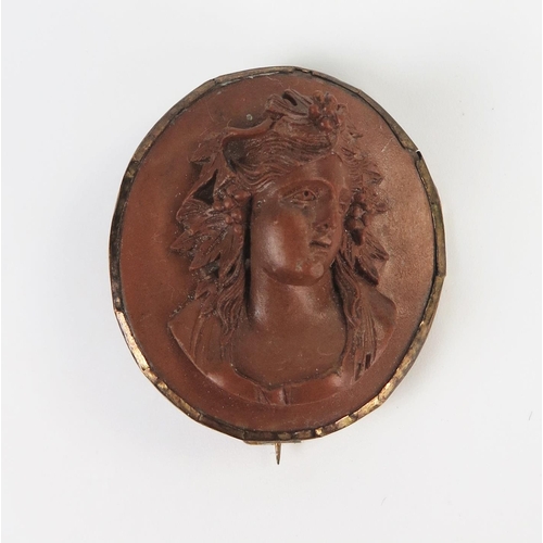 246 - 19th Century Carved Lava Cameo Brooch decorated with the bust of a lady, 35x31mm