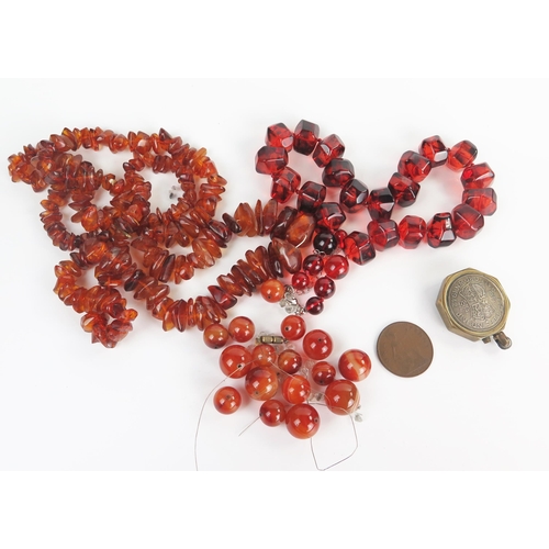 283 - Amber and Faux Amber Necklaces, loose agate beads, 1942 trench art half crown coin lighter and 1927 ... 