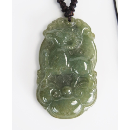 295 - Chinese Carved Jadeite Necklace decorated with a ram, 38mm drop