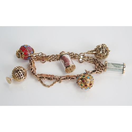 363 - 9ct Gold Charm Bracelet with multi jewel set charm, spinning globe, ewer, teapot and two folded note... 