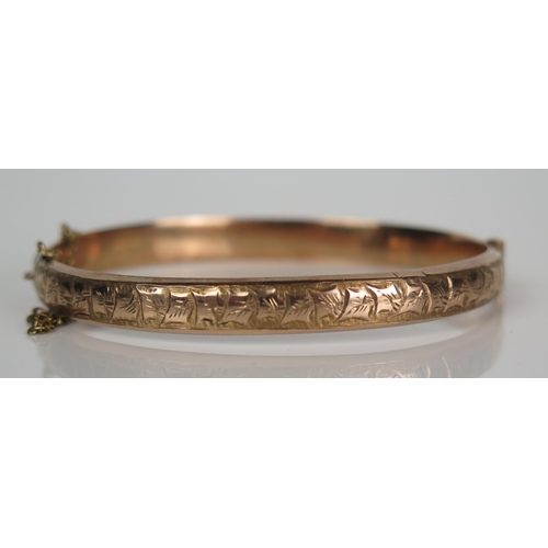 389 - Antique Cased 9ct Gold Hinged Bangle with chased leaf decoration, Birmingham 1919, AJ, 9.6g