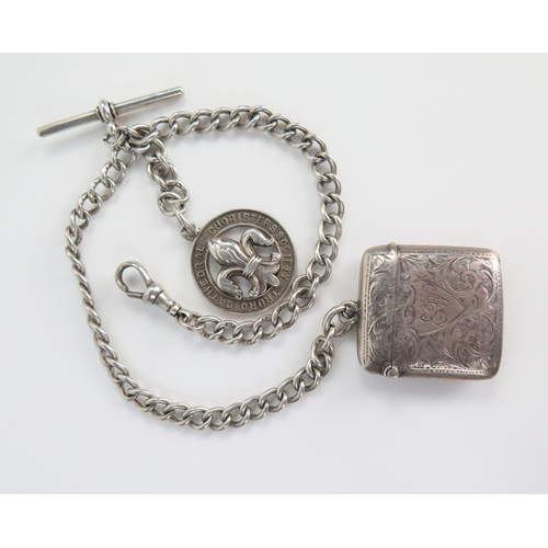 409 - Silver Albert with T-bar, vesta with chased foliate scroll decoration (Birmingham 1909, AJ) and fob,... 