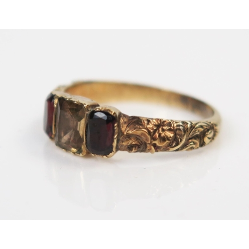 42 - A Georgian Foil Backed Garnet and Citrine? Three Stone Ring in an unmarked high carat gold setting w... 