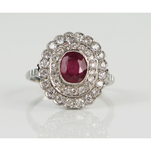 49 - Ruby and Diamond Cluster Ring in a millegrain setting and unmarked platinum or white gold setting, s... 