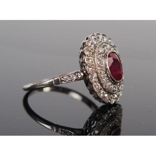 49 - Ruby and Diamond Cluster Ring in a millegrain setting and unmarked platinum or white gold setting, s... 