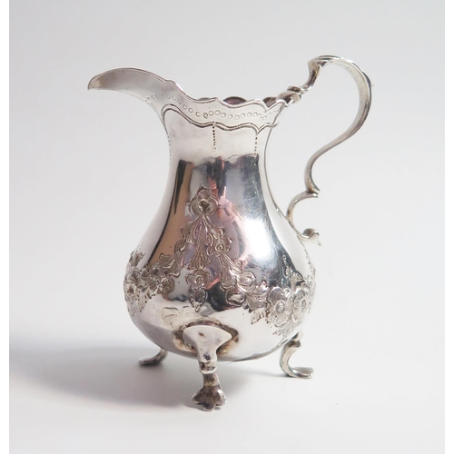 516 - A George II silver cream jug, of baluster form, high C scroll handle, raised on baluster legs, Londo... 