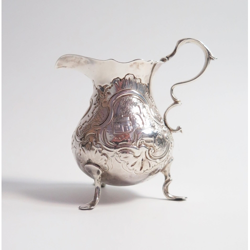 518 - A silver cream jug of baluster form, marks rubbed, embossed decoration, 9.5cm, 88 grams.