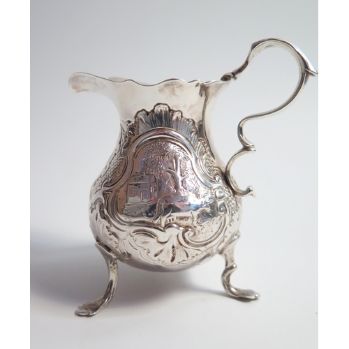 518 - A silver cream jug of baluster form, marks rubbed, embossed decoration, 9.5cm, 88 grams.