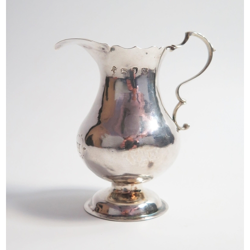 519 - A George III silver cream jug, of plain baluster form,  set on a spreading plinth base, London 1766,... 