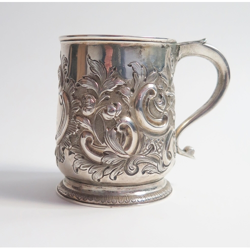 521 - A George II silver mug, of baluster form, later embossed decoration, London 1729, Matthew Lofthouse,... 