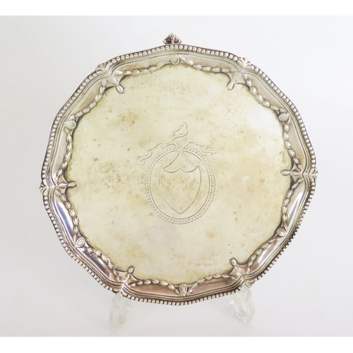 526 - A George III silver waiter, of circular form with shaped rim bead and swag bell flower decoration, s... 