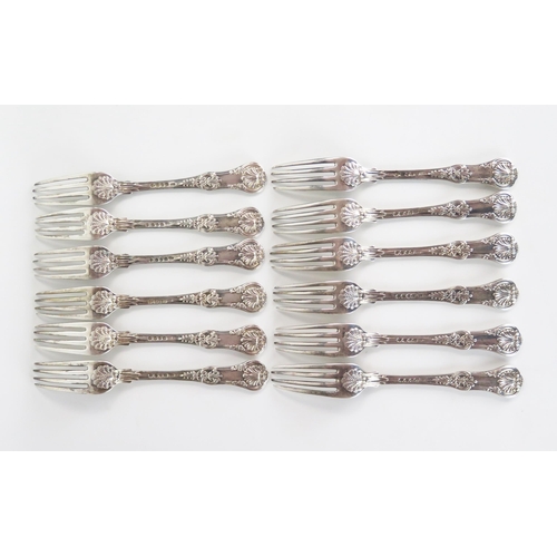 543 - Twelve George IV silver table forks, Queens Pattern, London 1823,  William Traies, some rubbing, pro... 