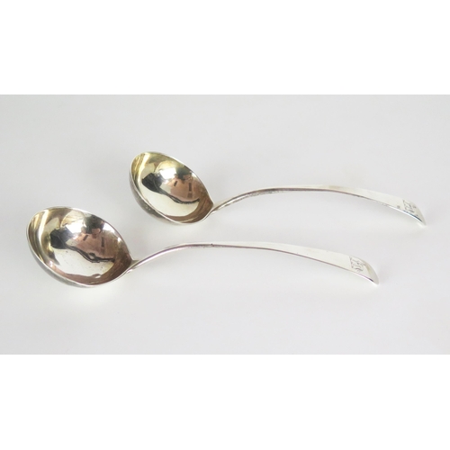 556 - A pair of George III silver sauce ladles, Old English Pattern, engraved standing dog crest, London 1... 