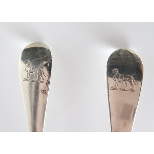 556 - A pair of George III silver sauce ladles, Old English Pattern, engraved standing dog crest, London 1... 