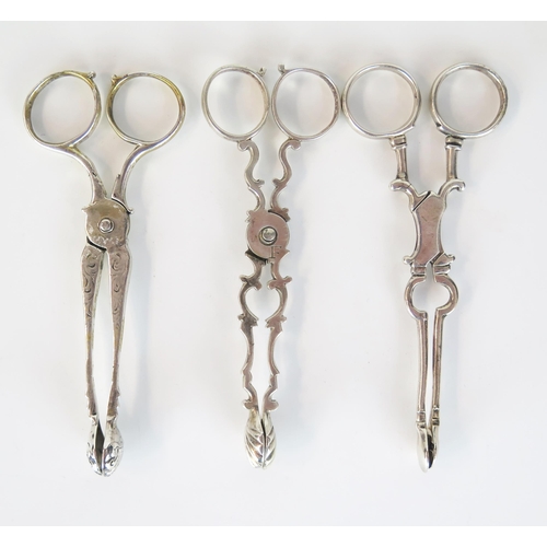 560 - Three unmarked white metal sugar tongs, probably George II, 80 grams approximately, (3).