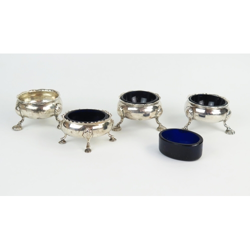 574 - Three Georgian silver salt cellars with two blue glass liners, together with a similar oval with two... 