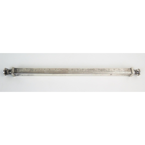 583 - An early 20th Century silver nine inch desk ruler, of square section, pull off seal top ends fitted ... 